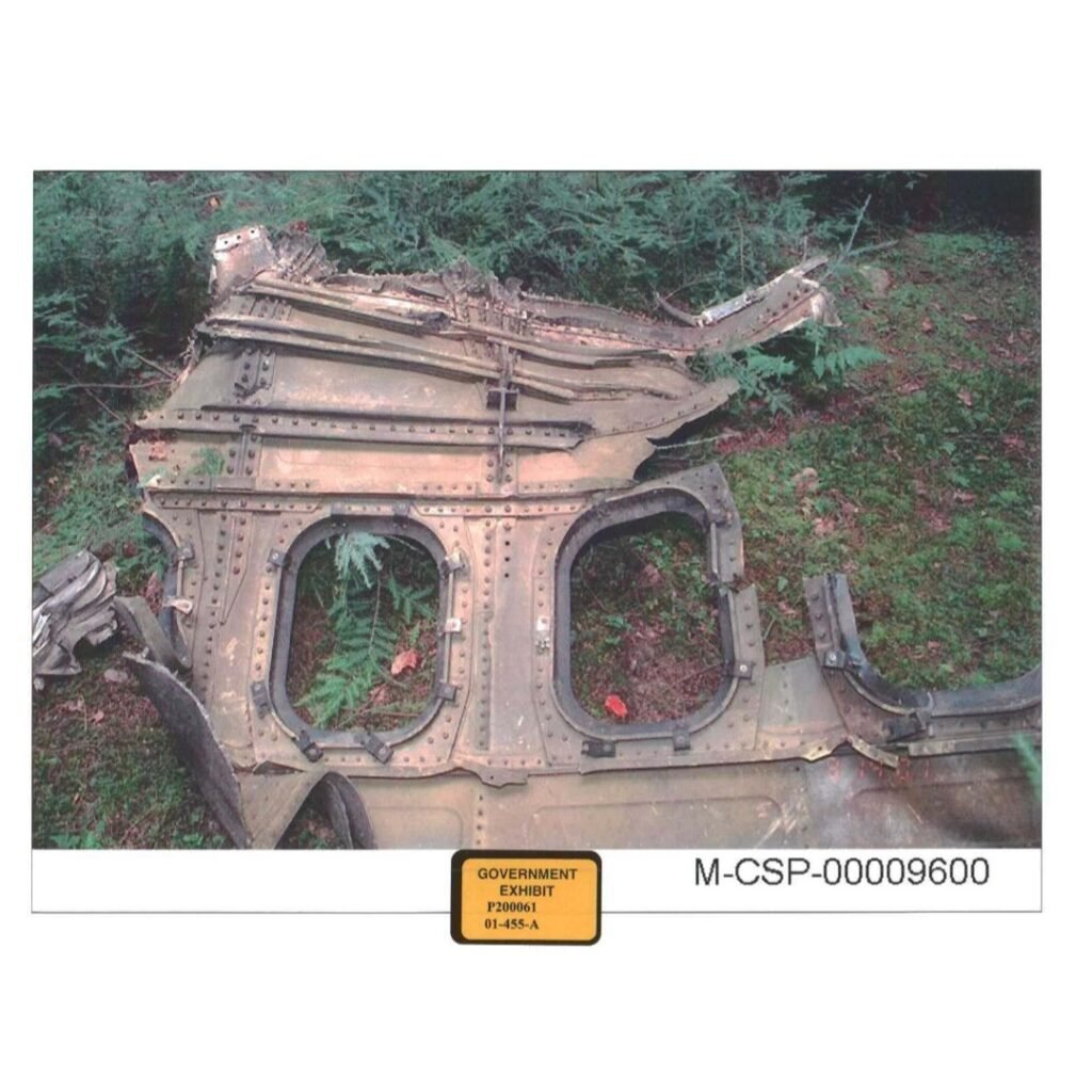 Flight 93 exterior panel with two window openings found in the debris field, documented by NPS staff during early investigation.