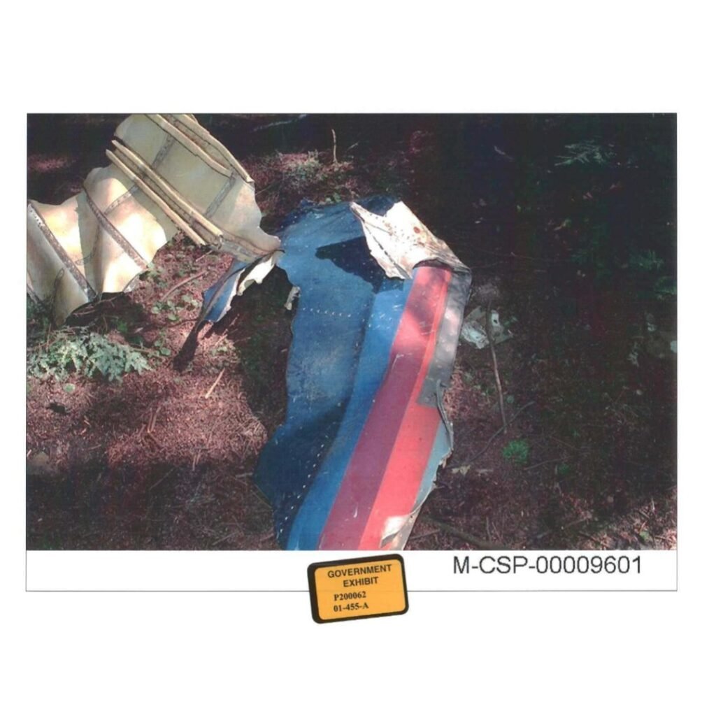 Recovered exterior panel from Flight 93 showing red, white, and blue paint, documented by NPS staff during the early investigation.